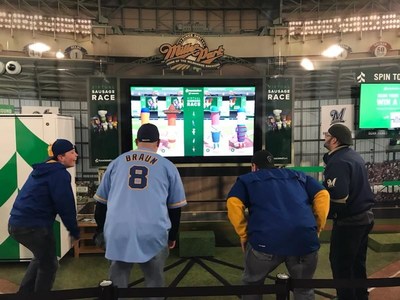 Fans participate in Associated Bank’s exclusive “virtual sausage race” as part of the enhanced Miller Park onsite experience