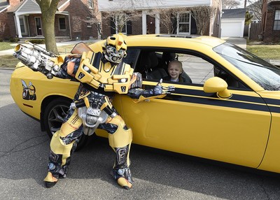 Beaumont Hospital, Royal Oak pediatric patient Hudson Brown poses with a Transformers character after completing proton therapy treatment at the hospital in Michigan.