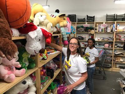 Employees sort school supplies at Treasures 4 Teachers as part of Bridgepoint Education and Ashford University's Heroes Day service project.