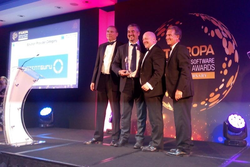 Mark Mamone from Serco (centre left) and Ed Winfield (centre right) from Content Guru receive the award at the Ceremony in the Royal Garden Hotel, London (PRNewsfoto/Content Guru)