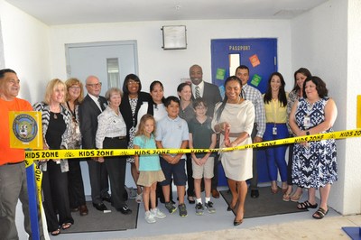 Palmetto Elementary School Principal Mrs. Gladys E. Harris cuts the ceremonial ribbon to formally open the school's new Carson Reading Room. The new reading room for students of the Elementary school was made possible by a Financial Grant from the BallenIsles Charities Foundation.