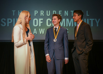 Olympic gold medalist and World Cup champion Lindsey Vonn congratulates Ryan Guggenheim, 18, of St. Paul (center) and Shrey Pothini, 14, of Savage (right) on being named Minnesota's top two youth volunteers for 2018 by The Prudential Spirit of Community Awards. Ryan and Shrey were honored at a ceremony on Sunday, April 29 at the Smithsonian's National Museum of Natural History, where they each received a $1,000 award.