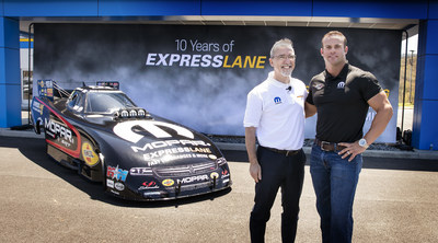 Pietro Gorlier (left), Head of Parts and Service (Mopar), FCA, and Mopar Express Lane NHRA Funny Car star Matt Hagan celebrate the grand opening of the new stand-alone Express Lane facility in Pulaski, Virginia, built and owned by Matt;s father, David Hagan.