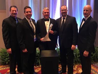 Bruce McDonald (center), chairman and CEO for Adient, accepts GM Overdrive Award during General Motors's 26th annual Supplier of the Year awards ceremony.