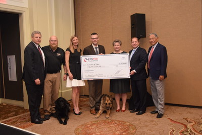 Please add the attached photo with the caption:  PenFed presents Leashes of Valor with a surprise $50,000 donation. Pictured left to right: Bruce Kasold, Acting President and COO of the PenFed Foundation, Matt Masingill, Canine Operations and Founder, Danique Masingill, President and Founder, and Jason Haag, CEO and Founder, of Leashes of Valor, Lisa Jennings, Senior Executive Vice President, PenFed Credit Union, PenFed Credit Union President and CEO James Schenck, and PenFed Foundation Chair The Honorable Frederick Y. Pang