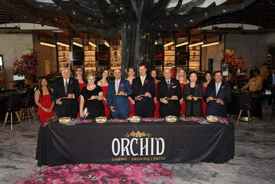 Live! Casino & Hotel executives, including Rob Norton (third from the left), President of Cordish Global Gaming, and Travis Lamb (fourth from left), General Manager of Live! Casino & Hotel, at the official cigar cutting marking the opening of Orchid Gaming & Smoking Patio. Orchid is Maryland’s first and only full service outdoor gaming area with table games and slots.