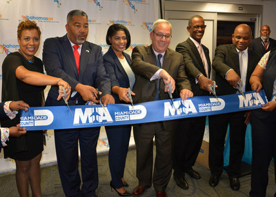 Miami-Dade Aviation Director Lester Sola (center) and officials from Bahamasair and the Bahamas cut the ceremonial ribbon at the launch of direct service to Bimini.