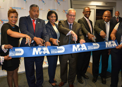 Miami-Dade Aviation Director Lester Sola (center) and officials from Bahamasair and the Bahamas cut the ceremonial ribbon at the launch of direct service to Bimini.