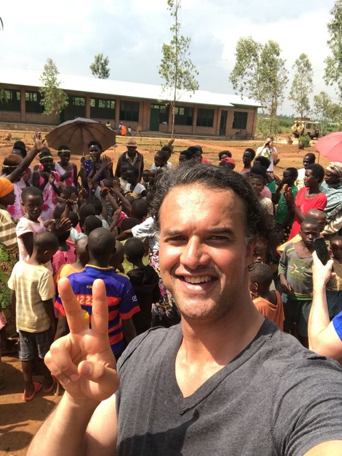Paxful CEO Ray Youssef stands in front of a nursery school in Rwanda that his company helped build by donating $50,000 in bitcoin. (PRNewsfoto/Paxful)