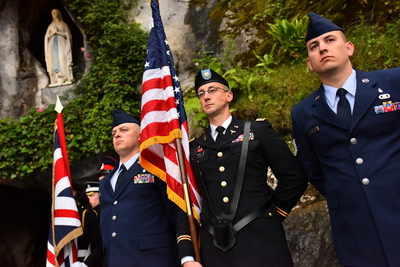 Color guards of several nations stand at attention in the grotto of the Shrine of Our Lady of Lourdes during the 2017 International Military Pilgrimage