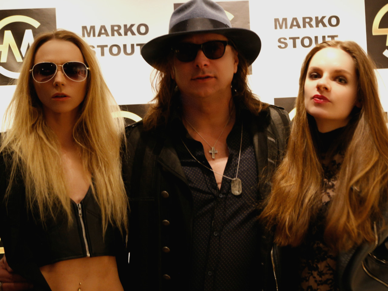 Marko Stout poses with models at his Artifact Gallery exhibition 03/04/18