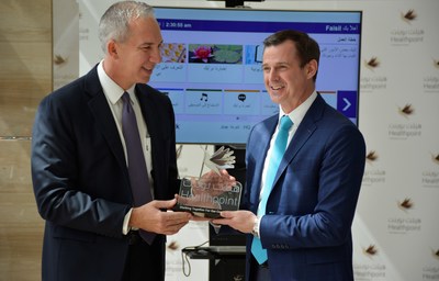 Abu Dhabi, May 15, 2018--Dr. Jose Lopez, CEO, Healthpoint presents a crystal plaque to Michael O'Neil, founder and CEO, GetWellNetwork.