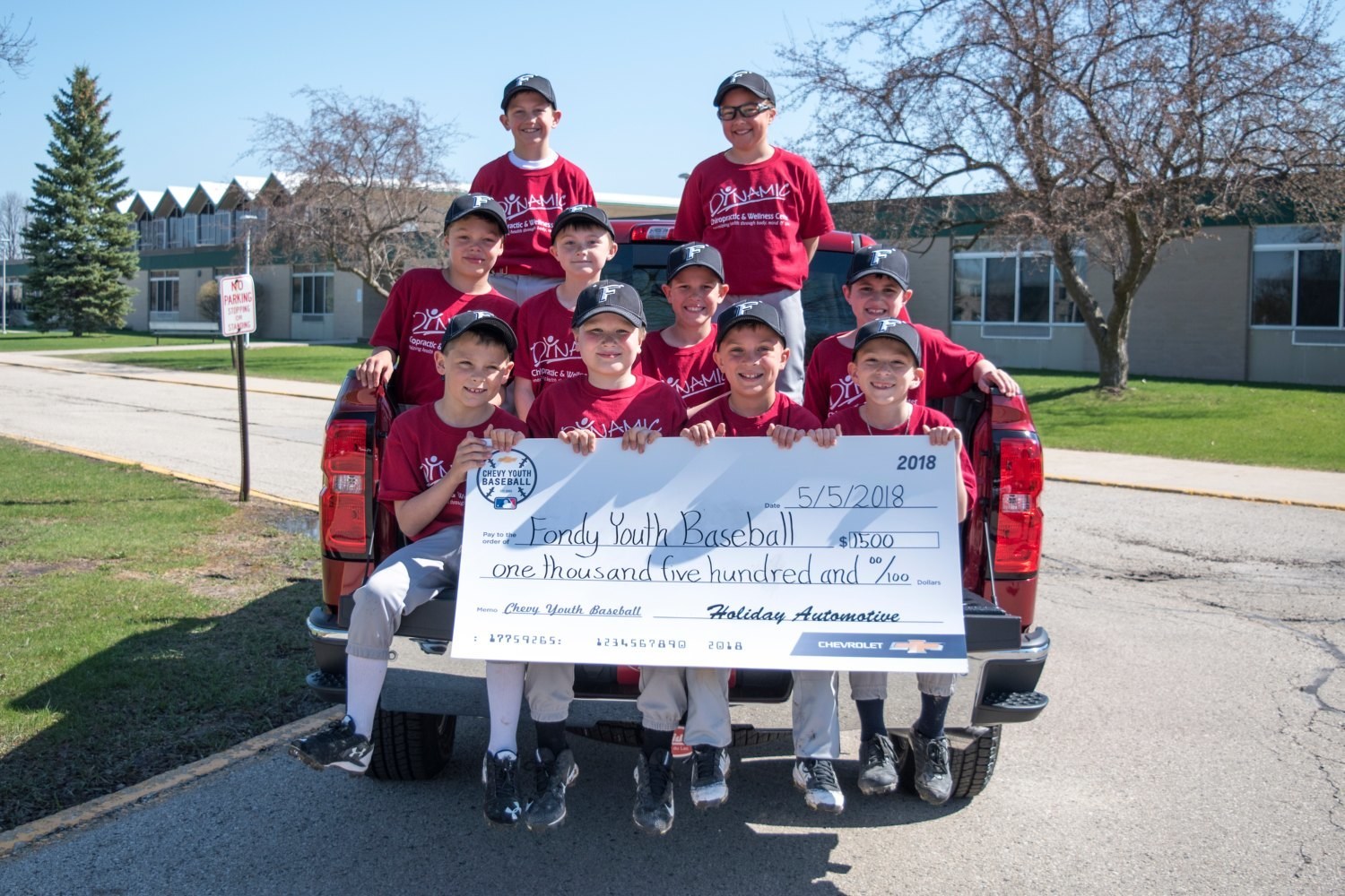 Local youth baseball team accepts check on behalf of the Fondy Youth Baseball organization.