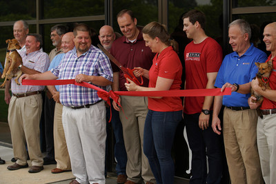 During a ceremony May 19, Rachel Miller, Site Manager of Nestlé Purina’s new Hartwell, Georgia facility, prepares to cut the ribbon and officially unveil the company’s new 19,000-sq ft distribution center, which will ship Purina dog and cat food to retailers in the southeast region of the U.S. Miller is joined by Purina colleagues, representatives from Hart County and the city of Hartwell, along with adoptable pets from local rescue organizations.