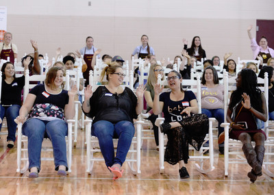 Expectant military mothers celebrate the news that they are going home with a gifted Cracker Barrel rocker at Operation Homefront’s Star-Spangled Babies shower.