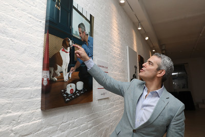 A touching moment; Andy Cohen reacts to a photo at Gallery 28 by Purina ONE®, which celebrates the brand’s ONE Difference Campaign in New York City on Tuesday, May 22. The gallery features never-before-seen photos of Andy and Wacha in their home. Purina ONE is donating $5, up to $28,000, to the Petfinder Foundation for every person who signs up for the Purina ONE 28-Day Challenge between May 22 and June 30 to help more dogs, like Wacha, find their forever homes.