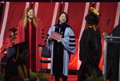 Massachusetts Secretary of Labor and Workforce Development Rosalin Acosta assists Bunker Hill Community College President Pam Eddinger with conferring Class of 2018 degree and certificates at College's 44th Commencement Ceremony