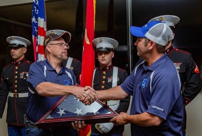 Veteran PepsiCo driver Mike Bedell hands off the American flag to Veteran PepsiCo driver Gary Rochell at the Plano, Texas stop of the 2018 PepsiCo Rolling Remembrance Relay