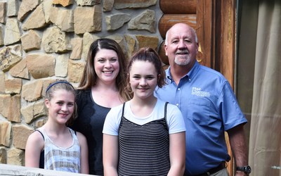 Jeff Chapman (right), owner of Chapman Heating and Air Conditioning, is pictured with the Allman family, recipients of a new Bryant Evolution home comfort system. 