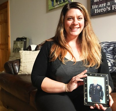 Jenni Allman holds a photo of her husband, First Sgt. Steven Allman, who is currently deployed to the Middle East. To honor Sgt. Allman as a Bryant True Hero, Chapman Heating and Air Conditioning, the 2017 Bryant Dealer of the Year, installed a donated Bryant Evolution home comfort system in the family's home.