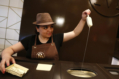 A MAGNUM Ice Cream bar being hand-dipped at MAGNUM New York. The premium “dipping bar” allows guests to create MAGNUM bars hand-dipped in Belgian chocolate and adorned with premium toppings, like culinary rose petals, hazelnut croquant and dark chocolate crispy caviar. Located at 132 Spring Street in SoHo. For more information, visit Facebook.com/MAGNUMUS. (Photo by Jason DeCrow for MAGNUM)