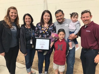 Silvia Serratos, mother of a No Excuses University school student and recipient of a full scholarship to Ashford University, with her family, principal, and Ashford University representatives.