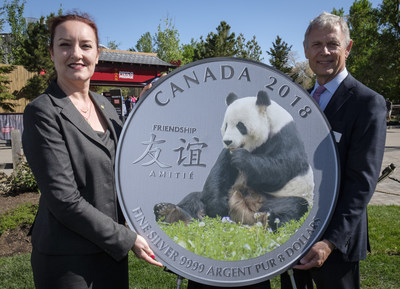 From the left : Francine Hochereau, vice-president, marketing and communications at the Royal Canadian Mint and Greg Royer, chief operating officer at the Calgary Zoo unveil the fine silver coin “The Peaceful Panda: a Gift of Friendship” (CNW Group/Royal Canadian Mint)