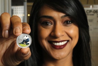 Minister of Small Business and Tourism Bardish Chagger holds the fine silver coin “The Peaceful Panda: a Gift of Friendship” after participating in a ceremonial coin strike at the Royal Canadian Mint on Friday in Ottawa. This year marks the Canada-China Year of Tourism (CNW Group/Royal Canadian Mint)