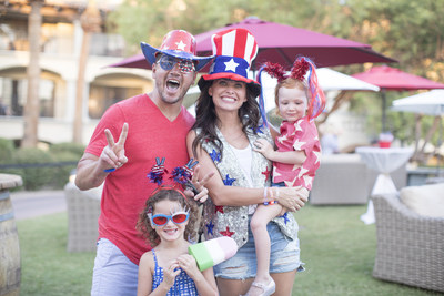 A festive family enjoying the 4th of July Freedom Fest at the Fairmont Scottsdale Princess in Arizona. This AAA Five Diamond hotel offers a line up patriotic festivities, concerts, fireworks and a vintage air show of planes flown by veterans. A portion of proceeds from vacation packages benefit Friends of Freedom, which supports military families.