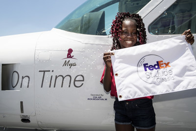 St. Jude patient Mya poses after unveiling her name on a FedEx Express Cessna Caravan that was named in her honor as part of the FedEx Purple Eagle program.