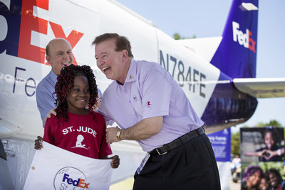 St. Jude patient Mya smiles with David J. Bronczek, President and COO of FedEx Corp., after unveiling her name on a FedEx Express Cessna Caravan that was named in her honor.