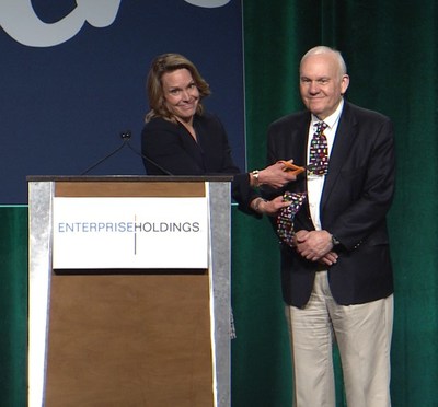 Enterprise Holdings Executive Vice President and Chief Operating Officer Christine Taylor cutting the tie off her father, Executive Chairman Andy Taylor, marking the end of a 60-year Enterprise tradition.