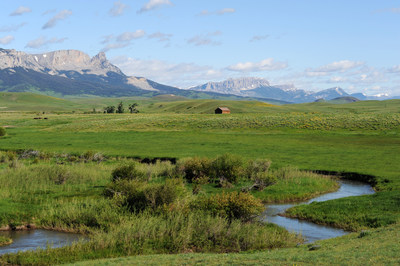 Ford Creek and Historic Ranch Structure with backdrop of the Rocky Mountain Front