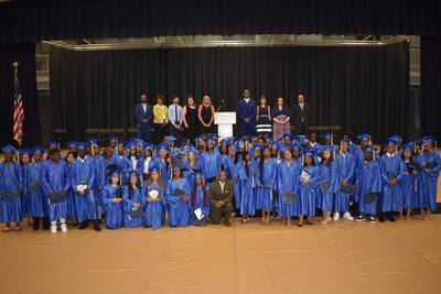 Chester Mayor Thaddeus Kirkland (front row, center) shown with eighth-grade graduates of Chester Community Charter School, at commencement ceremonies held at Neumann University, after presenting the commencement address to the students. Also shown, at top, are school administrators and faculty members, including Dr. David Clark, chief education officer(far left); Dr. Linda Portlock (second from left), deputy superintendent; and Terrane Polnitz, Aston Campus Principal(fourth from right).