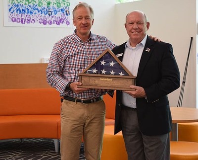 Mark Rayfield, President/CEO of CertainTeed, was presented with the flag that flew during the Key Ceremony of the 250th home completed by Homes For Our Troops (HFOT). The flag was presented by HFOT President Brigadier General (Retired) Tom Landwermeyer.