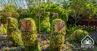 A topiary giant emerges from the ground to greet guests in Phipps Conservatory's immersive Summer Flower Show: Gardens of Sound and Motion.