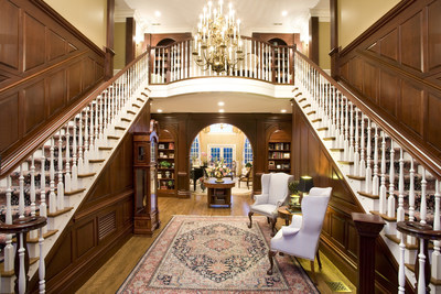 The regal, two-story foyer of the main estate features dual staircases, and provides a grand entry for family and friends. More at VirginiaLuxuryAuction.com.