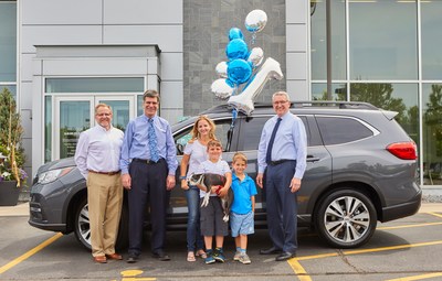 Subaru sells first 3-row Ascent SUV. (L to R) Mark Schreiber, Don Sommer, Samantha Ernest, Caiden Henderson, Brewer the dog, Oliver Henderson, and Wally Sommer