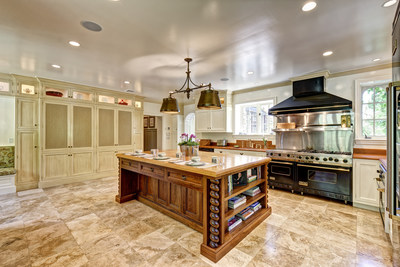 A spacious gourmet kitchen offers ample room for the busiest of domestic chefs. The kitchen includes commercial-grade Viking appliances and a charming, wood-burning fireplace. Discover more at CTLuxuryAuction.com.