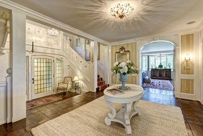 An elegant yet warm foyer welcomes guests to the home and offers plenty of room for festive gatherings. Discover more at CTLuxuryAuction.com.