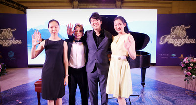 Piano megastar Lang Lang gesturing a high five with his young scholars