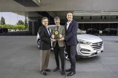 Hyundai executives receive Tucson's J.D. Power IQS award for the small SUV segment. Pictured (left to right): Brian Smith, COO, Hyundai Motor America; Geoffrey Mortimer-Lamb, Vice President, Head of Global Product Development, J.D. Power; Omar Rivera, Director, Quality and Service Engineering, Hyundai Motor America.