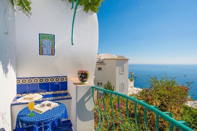 The beautifully updated Casa del Fico villa, with authentic architectural features, offers stunning sea views, lush gardens and a terrace for outdoor lounging and dining.