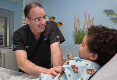 Jose Prince, MD, trauma medical director at Cohen, evaluates a youngster.