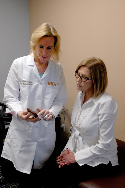 MDVIP Chief Medical Officer Dr. Andrea Klemes (left) consults a patient on using a nutrition app. MDVIP and Ipsos published a national survey that reveals significant deficiencies in how much Americans know and understand about diets and weight management. (Credit: MDVIP)