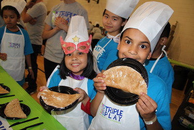 Club kids make a healthy snack at Boys & Girls Clubs of America's Triple Play Day made possible by the Anthem Foundation and The Coca-Cola Company