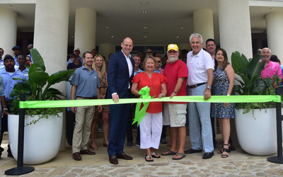 CLUB WYNDHAM owners Renee and Bill Binkley (center, in red) cut the ribbon to officially reopen the Margaritaville Vacation Club resort in St. Thomas with Wyndham Destinations President and CEO Michael D. Brown (left) and Margaritaville President of Development Jim Wiseman (right).