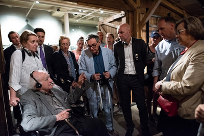 Holocaust Survivor Roman Kent (immediate left) sharing his experience with German State Secretary Dr. Rolf Bosinger (third from right side), in a cattle car like those used to deport Jews, at the United States Holocaust Memorial Museum during negotiations for increased social services for Holocaust survivors. Photo credit: Jason Colston