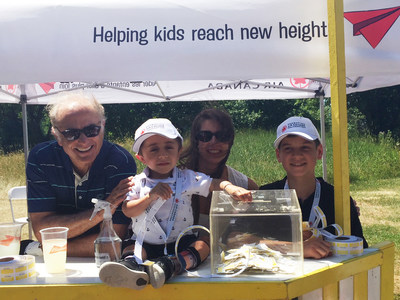 Calin Rovinescu, President and Chief Executive Officer at Air Canada, Kaleb, Kaleb’s mom and Justin at the lemonade stand at the Air Canada Foundation’s seventh annual golf tournament. (CNW Group/Air Canada Foundation)