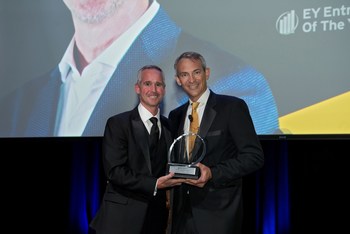 Jon Ziglar (left), CEO of ParkMobile, accepts the EY Entrepreneur of the Year Award.